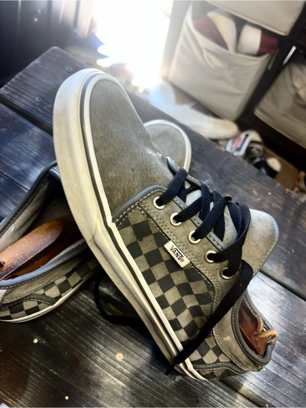 Vans gray suede sneakers with black & white checkerboard pattern on the side